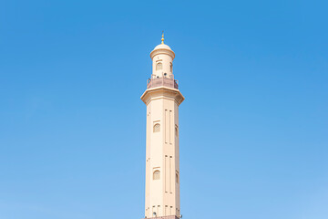 minaret of a mosque from muslim islamic culture, minarets blue sky , historic traditional minaret
