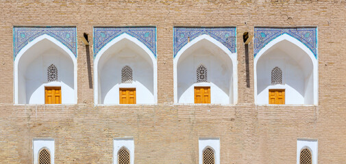 White niches of the cells at the facade of Muhammad Amin Khan medrese. Fragment of facade. Khiva....