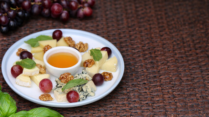 cheese plate with grapes and honey