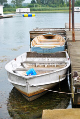 Fototapeta na wymiar Row Boats Tied to a Wooden Dock