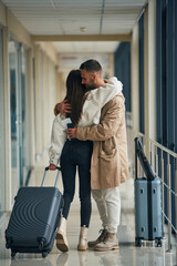 Farewell, embracing each other. Couple are in the airport hall together