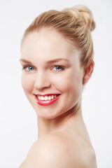 Portrait, beauty and woman in studio with makeup, cosmetics and happy by white background. Female model, smile and skincare in glow face with red lipstick and blonde hair for confidence in foundation