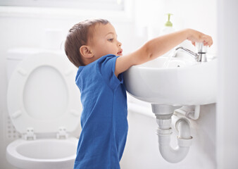 Child, boy and washing hands in bathroom, hygiene and prevention of germs or bacteria at home. Male person, kid and learning at basin or cleaning and sanitary care, water and disinfection for safety - obrazy, fototapety, plakaty