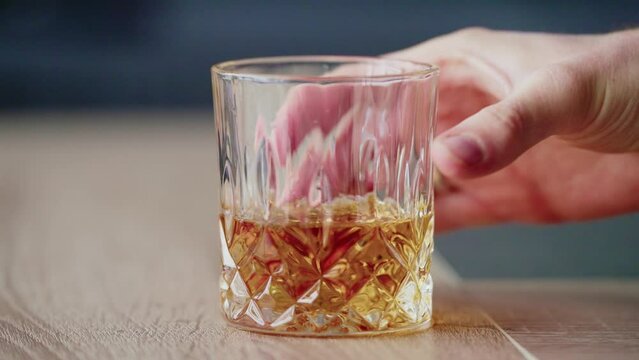Hand Holding Whiskey Glass