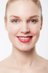 Obraz premium Portrait, red lipstick and woman in studio with makeup, cosmetics and happy by white background. Model, glow face and confident with beauty aesthetic, blue eyes and blonde hair with skincare results