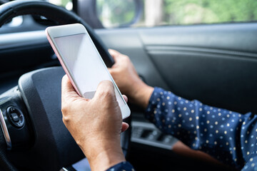 Holding mobile phone in car to communication with family and friends.