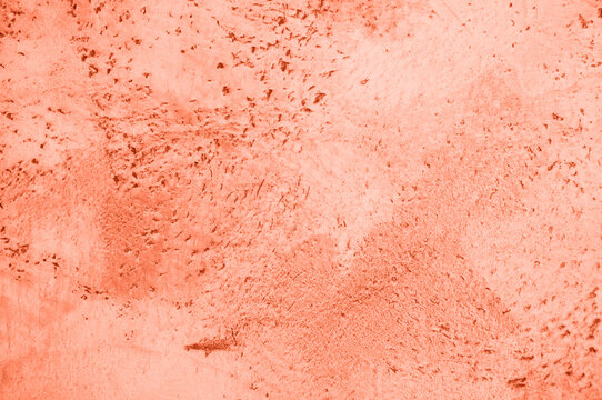 background, texture of concrete and stone in the color of 2024 peach fuzz. High quality photo