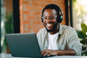 African american man enjoying watching webinar on laptop. Smiling mixed race businessman holding video call with clients partners.