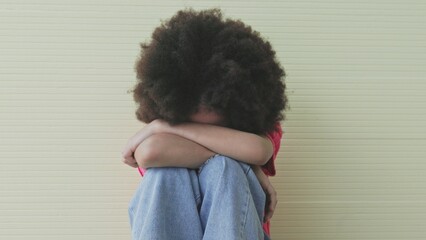 Unhappy girl, Sad child sitting hugging knees alone and lonely - obrazy, fototapety, plakaty