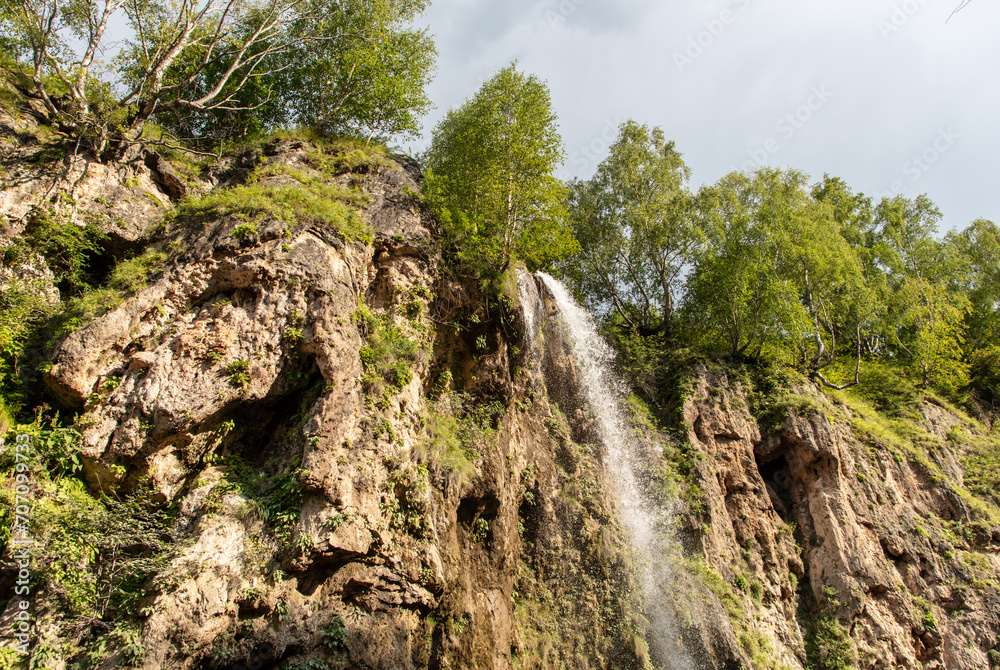 Sticker waterfall on a rocky river in the mountains