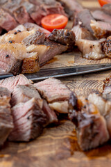 A steak on a cutting board with herbs and spices.Grilled beef tenderloin steak on a wooden board with grilled vegetables. Filet Mignon recipe concept, selective focus