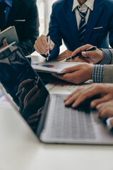 Business team Two managers work on accounting documents and the team works together to give...