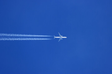 Airplane track on clear blue sky