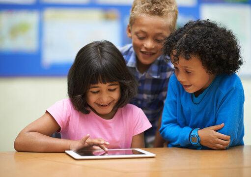 Students, children on tablet and school for online education, e learning and website or information in group. Happy kids in diversity with digital technology for knowledge and classroom development