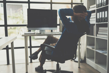Asian businesswoman stretches her arms and stretches to relax tired muscles from working at a desk...