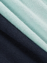 example of bath towels. mint and navy blue black. example of color and pile, macro details