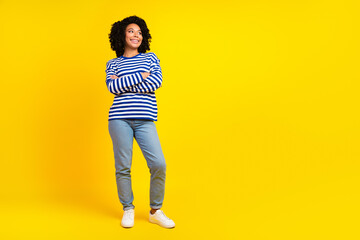 Full size photo of satisfied woman dressed striped shirt arms crossed look at discount empty space...