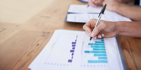 Business hands, paperwork and writing with data analysis, graphs and charts for financial report...