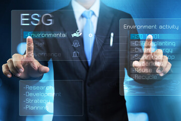 ESG environmental social governance concept with businessman touch on virtual screen to research...