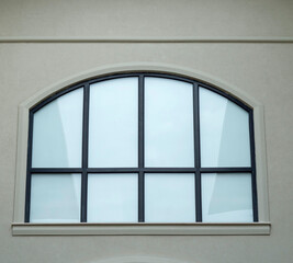 New arched window  on white wall closeup