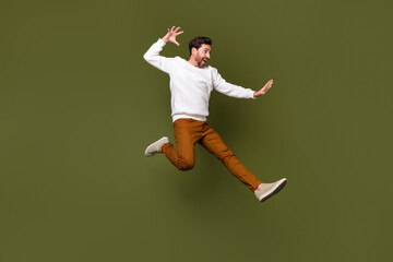 Full length photo of attractive cheerful guy wearing trendy clothes fighting empty space isolated...