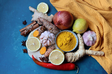 Immune system booster ingredients top view photo.  Spices and herbs on a blue background with space for text. Healthy eating concept. 