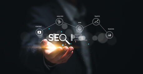Businessman hold virtual SEO icon to analyze SEO search engine optimization for promoting ranking...