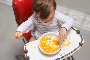 Baby eating, high chair and food, nutrition and health for childhood development and wellness....