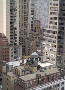 A detailed look from above at Midtown Manhattan, showcasing the dense urban landscape with a water tower of New York City living.