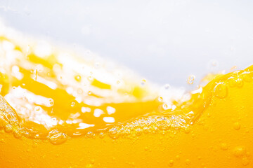 Close up bright orange juice splash texture for health and nature waves, Beautiful waves curve and little bubbles smooth for garphic design and background