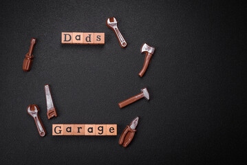 Tools and inscriptions symbolizing repairs or a garage and its attributes on a plain background