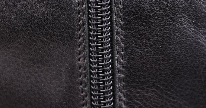 parts and details of clothing made of black leather, close-up of black leather with zipper