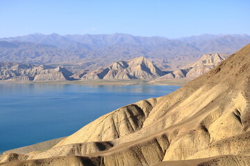 Beautiful landscape with Toktogul lake under colourful barren mountain range, Tien Shan range,...