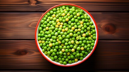 Green peas in white bowl on wooden background, top view