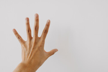 Image of woman's hand showing numbers five, counting fingers gesture, back hand, touching stop...