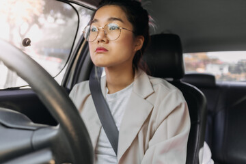 Front view of Asian Thai woman sleepy drowsiness while driving a car on road, going work with bored...