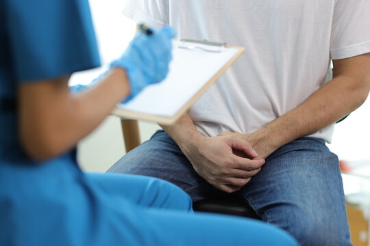 Doctor is diagnosing male erectile dysfunction and giving treatment recommendations, male health problems.