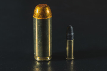 The weakest pistol cartridge is 22lr and the most powerful is 50AE. Macro photo.