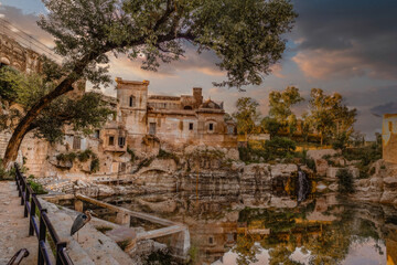 Fototapeta na wymiar Golden Hour Reflection of Ancient Mediterranean Structure with Heron, Serene Historic Site with Nature