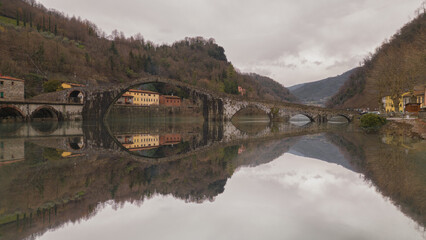 Devil's Bridge, Tuscany. Lucca. Suspension bridge over mirror water.