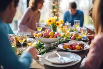 Fotobehang Happy multi generational family having Easter dinner together, table setting with traditional food and spring flowers for Easter celebration © pilipphoto