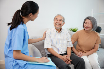 nurse or caregiver meeting and talking with about health with senior couple