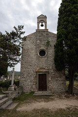 Fototapeta na wymiar Small Roman Old Church of St. Mary and cemetery of Osor town, Cres Island - Croatia