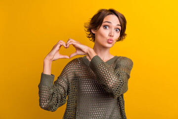 Photo of pretty cute girl dressed stylish clothes demonstrate heart figure sending you sweet air...
