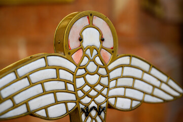 A dove, the symbol of the Holy Spirit, on the cover of a baptismal font in Church of Saint Giles...