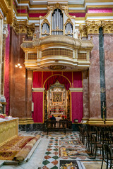 view of an ornate side chapel and pipe organ in the Metropolitan Cathedral of St. Paul in Mdina