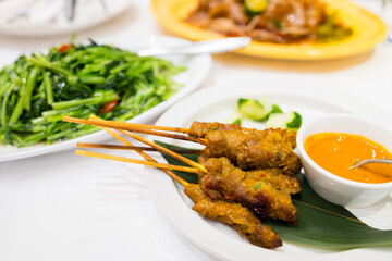 Check meat satay dish in restaurant