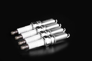 Spark plugs on a black background