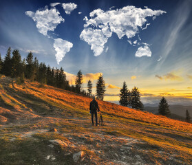 clouds in the form of a world map over the river canyon. tourist in the mountains enjoys the view. conceptual landscape 
