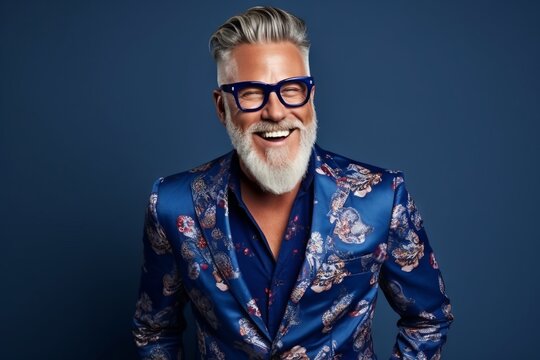 Portrait of a stylish senior man in a blue jacket and glasses.